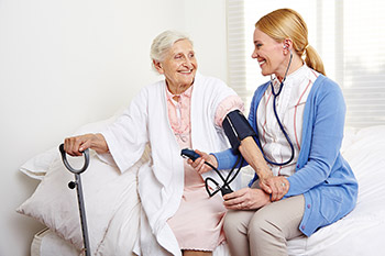 Doctor Checks Senior Citizen's Blood Pressure